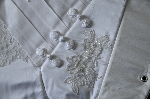 Close up of the details, pleating, frogs and applique.