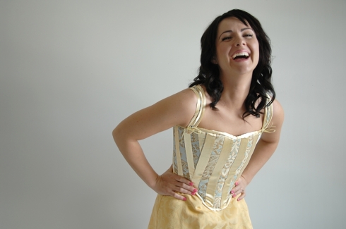 Elizabeth laughs in the matching corset.